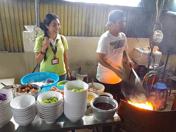 Bangkok food preparation with a flaming wok